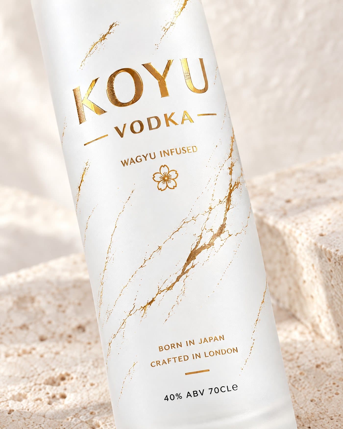 The gold foil lettering and gold veins on the frosted glass, seen close